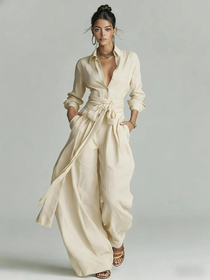 Full-length view of women's shirt collar jumpsuit with matching waist belt and long sleeves