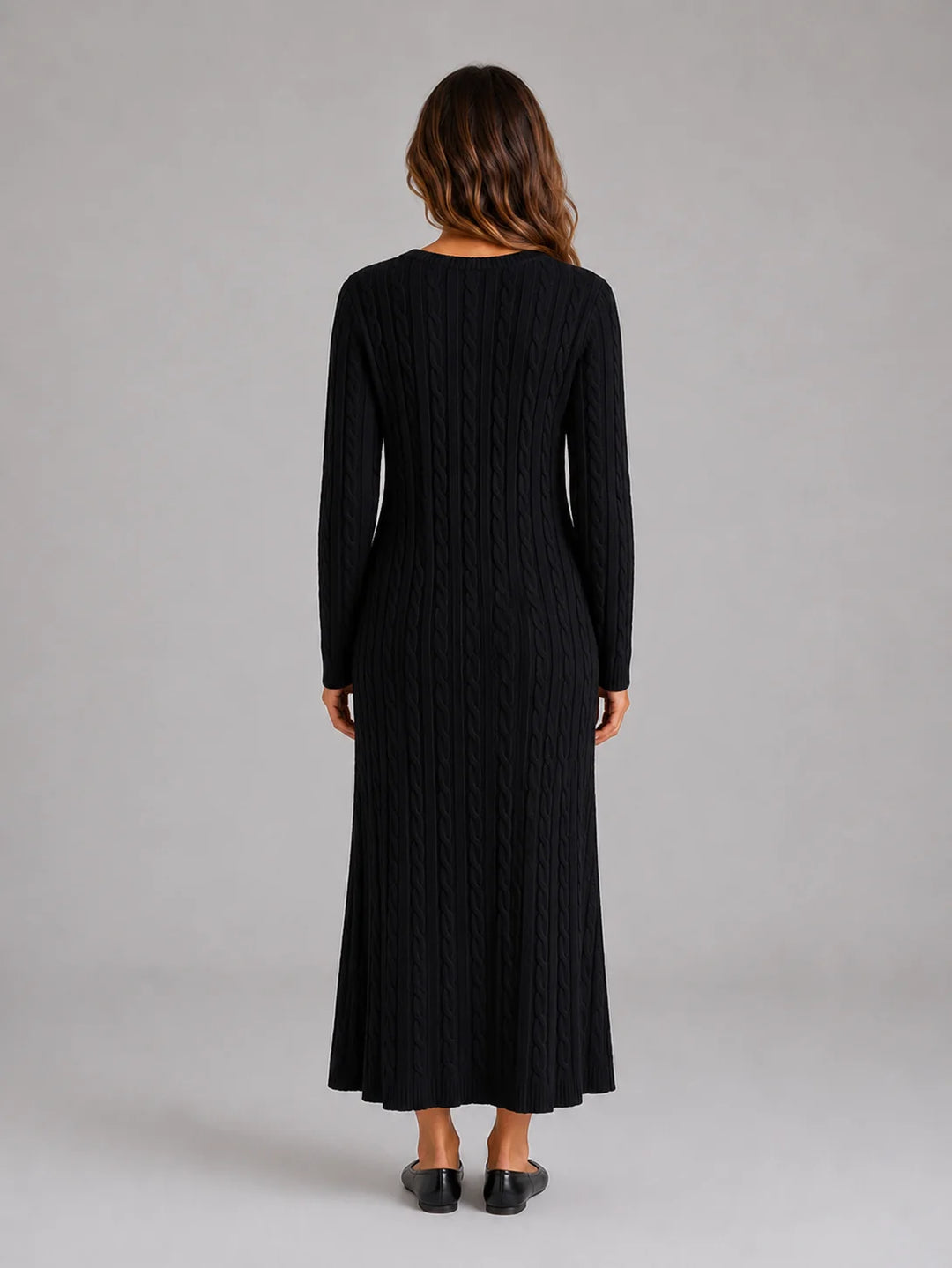 Detail shot of soft knit fabric and cable pattern on long sleeve jumper dress