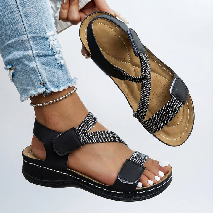 Side view of pink orthopedic sandals showing ankle strap adjustment and lightweight sole design