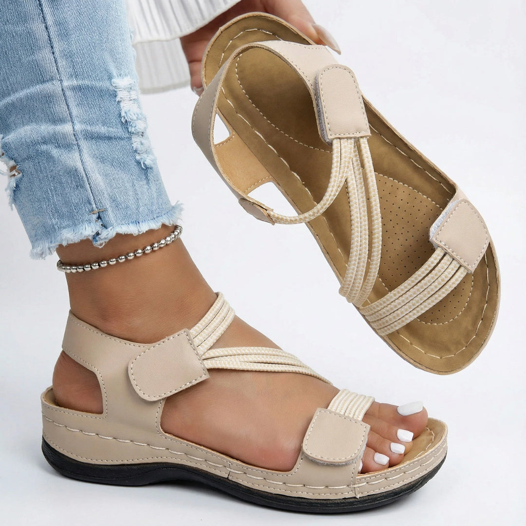 Pink orthopedic sandals with adjustable straps and cushioned insole paired with casual summer outfit