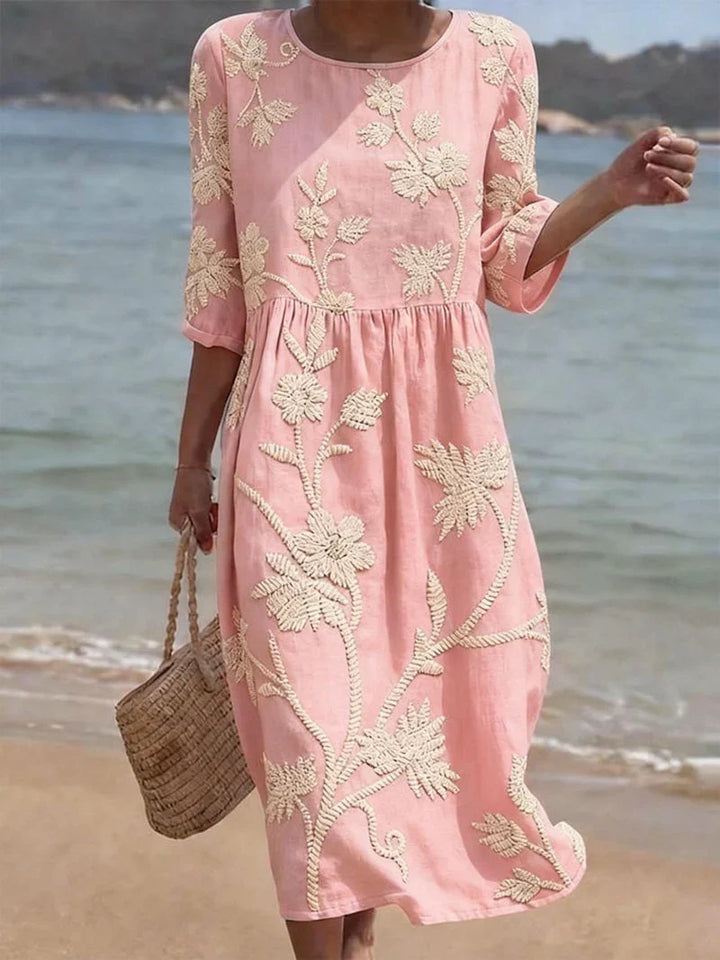 Side view of relaxed fit embroidered floral midi dress with three-quarter sleeves