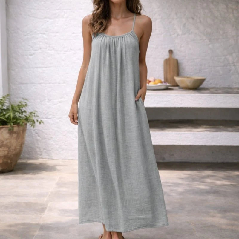White spaghetti strap dress with flowing skirt and low back detail for warm weather