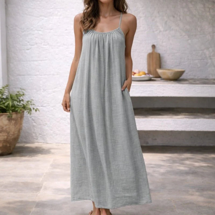 White spaghetti strap dress with flowing skirt and low back detail for warm weather