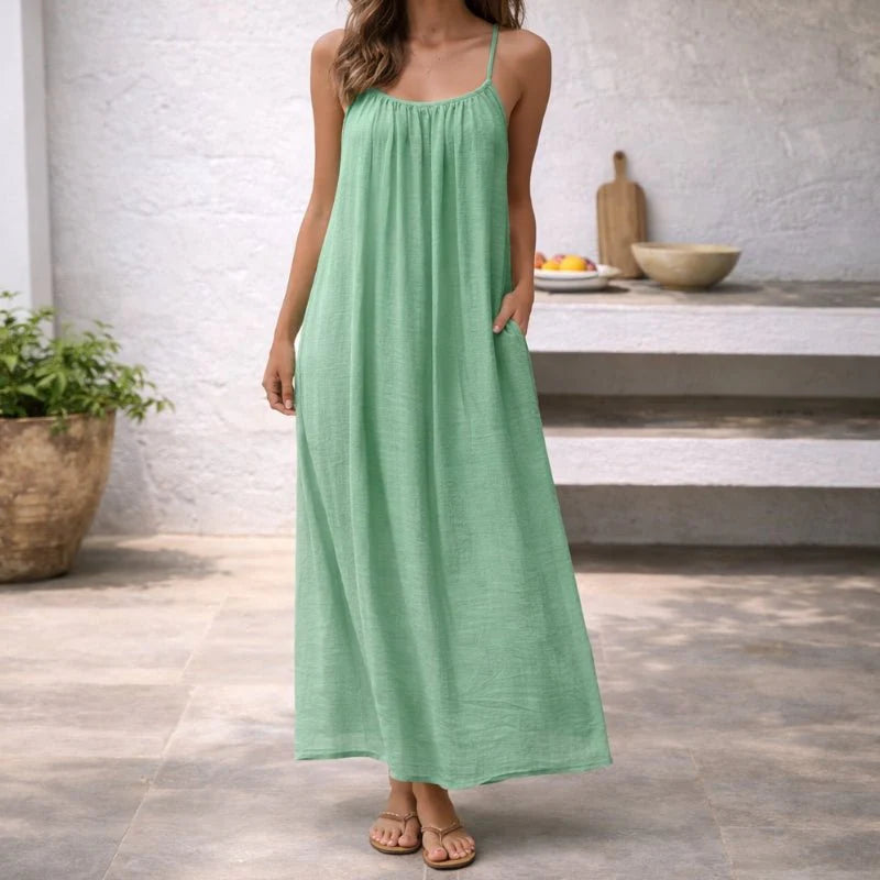 White maxi dress with thin adjustable straps and soft draping for everyday wear