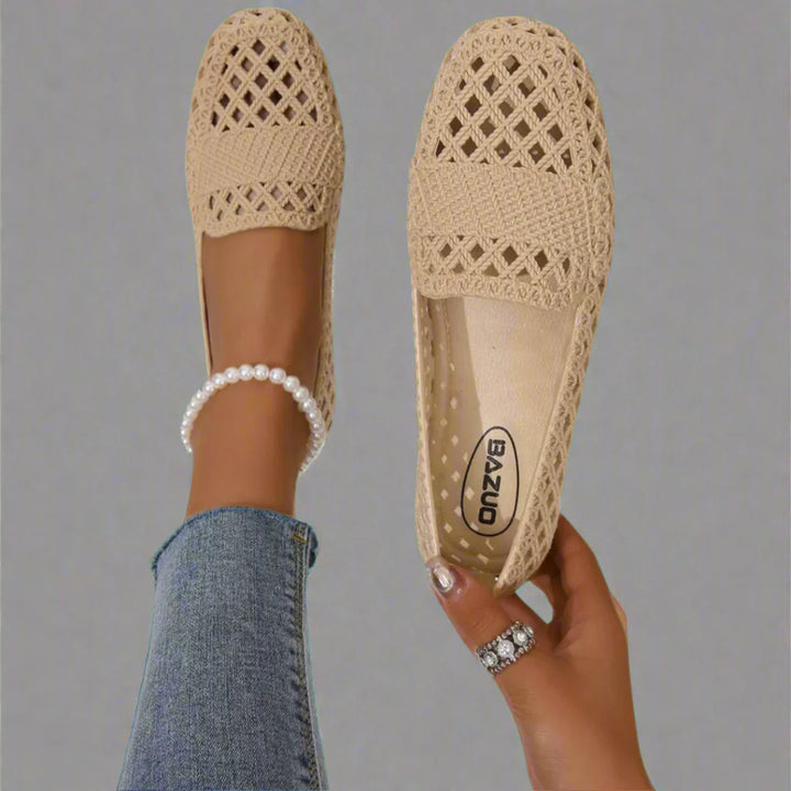 Woman wearing beige crochet espadrille flats with open-weave upper and slip-on design for casual summer wear