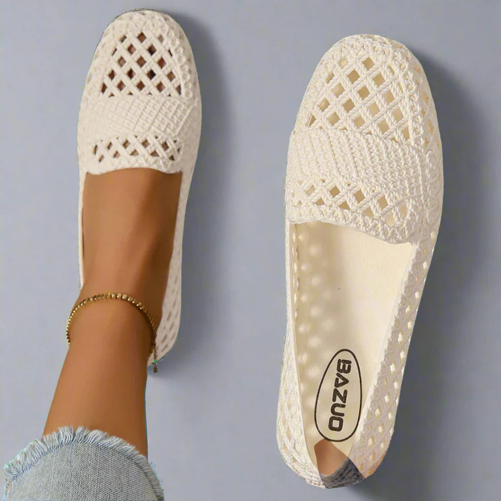 Close-up of beige crochet espadrille flats showing lattice woven upper and cushioned insole for all-day comfort