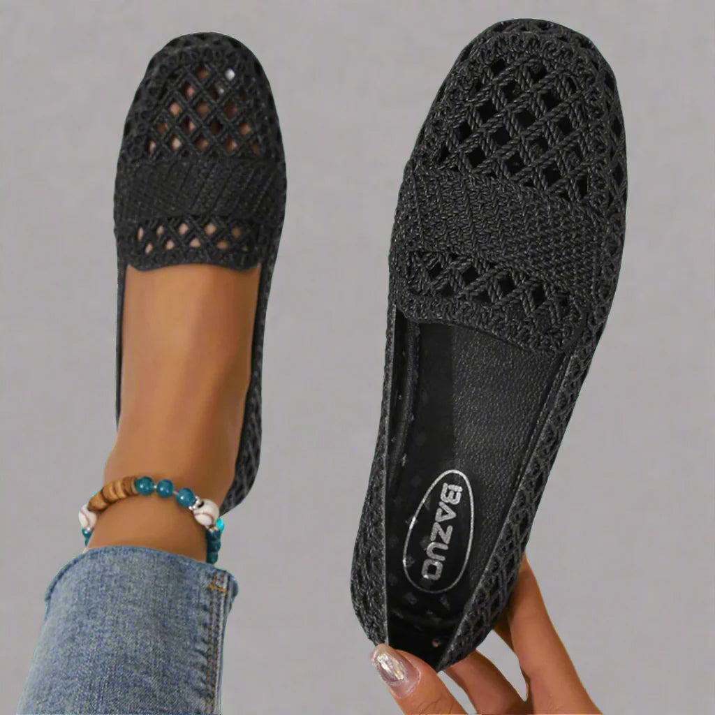 Side view of beige crochet espadrille flats with flat sole and rounded toe paired with denim jeans