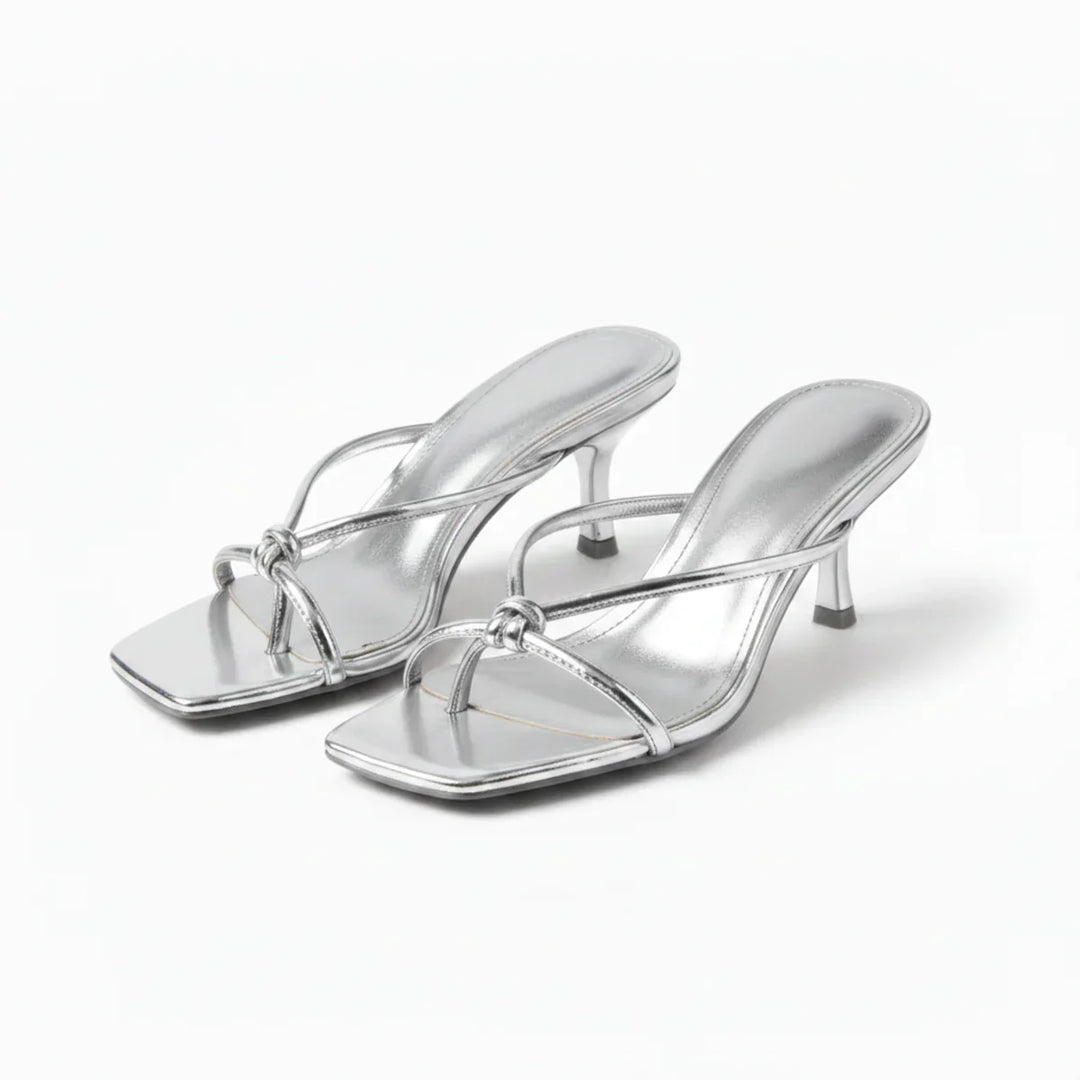 Full view of women's heeled sandals showing slip-on construction and mid-height heel