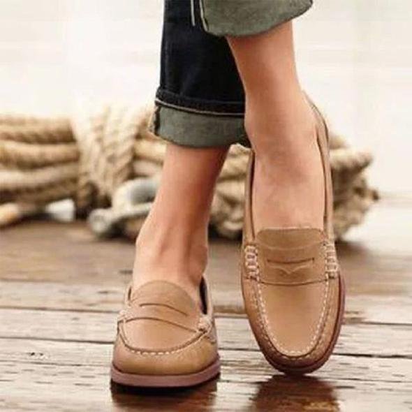 Classic penny loafer design with smooth leather upper and slip-on construction for effortless daily wear
