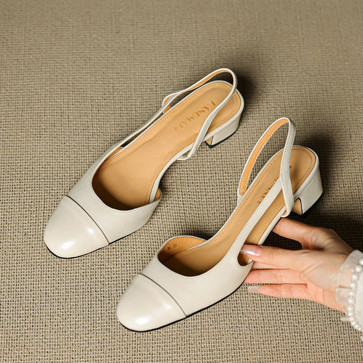 Side profile of women's block heel pumps showing open-back design and smooth leather finish