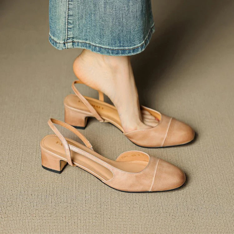 Close-up of almond-toe slingback pumps showing structured leather finish and adjustable heel strap