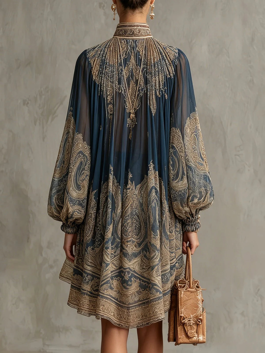 Close-up of baroque print high-neck chiffon dress showing intricate metallic pattern and sheer fabric detail