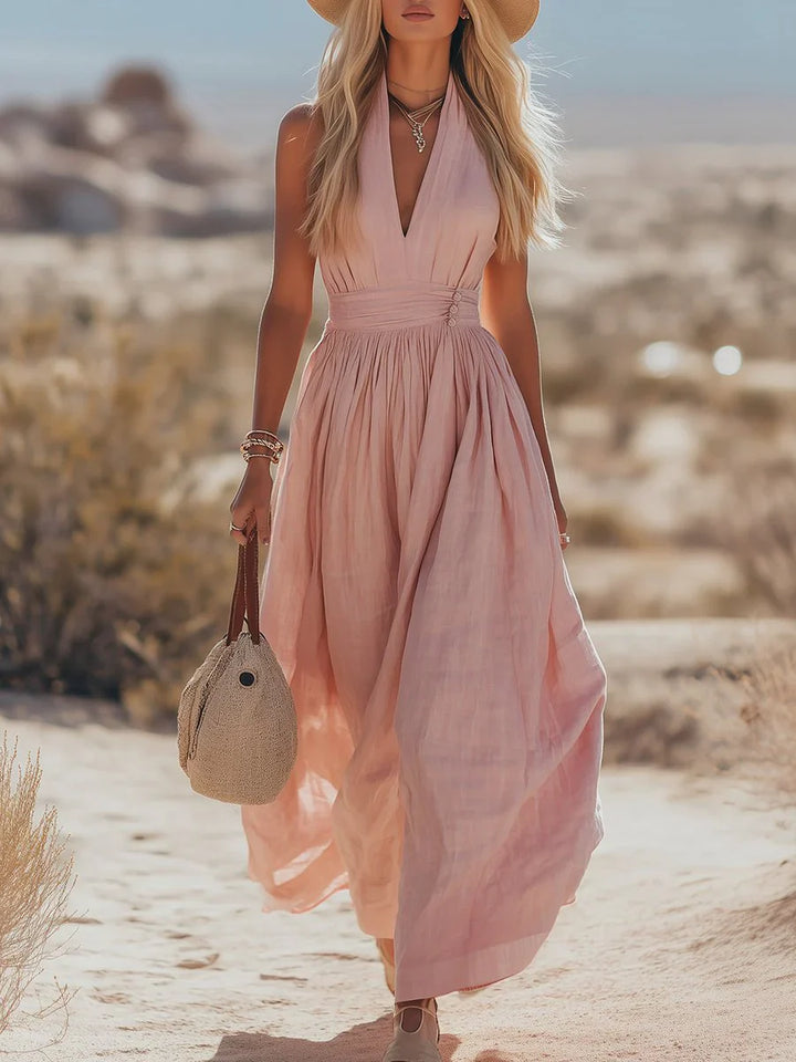 Halter maxi dress with plunging V-neckline and gathered empire waist detail in flowing dusty rose fabric