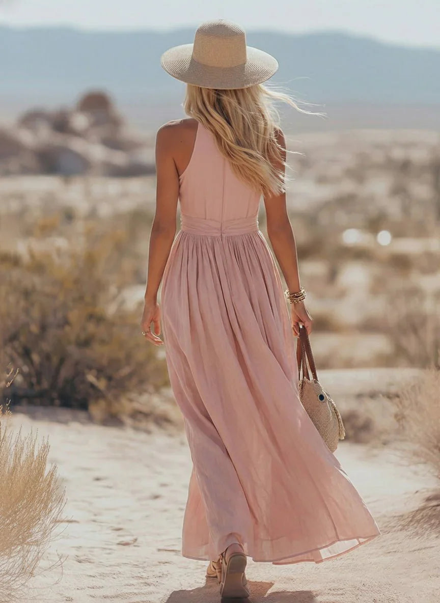 Detail of gathered waist and halter tie closure on sleeveless maxi dress with breathable fabric