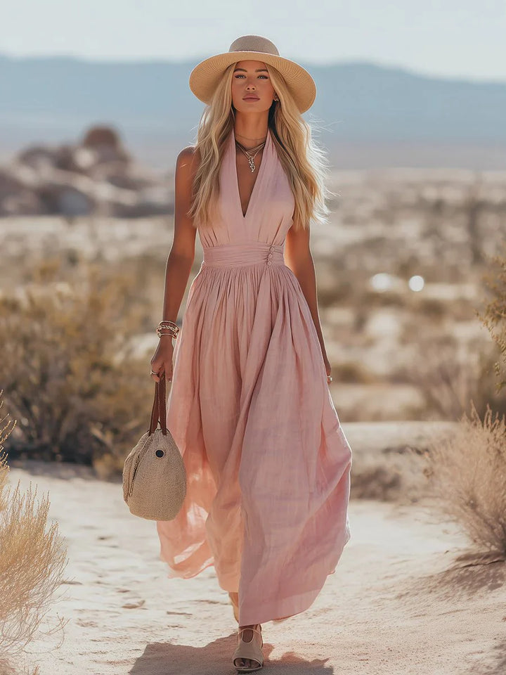 Halter maxi dress styled with straw hat and woven bag for coastal holiday outfit inspiration