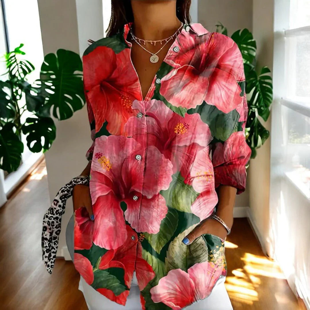 Women's floral print blouse with oversized pink hibiscus pattern and button-through front detail