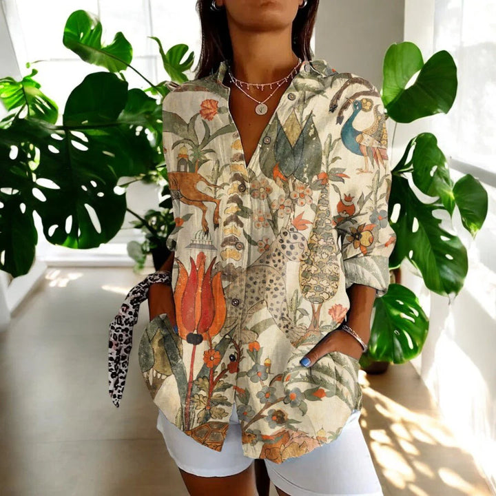 Side view of relaxed fit floral blouse with three-quarter sleeves and classic collar