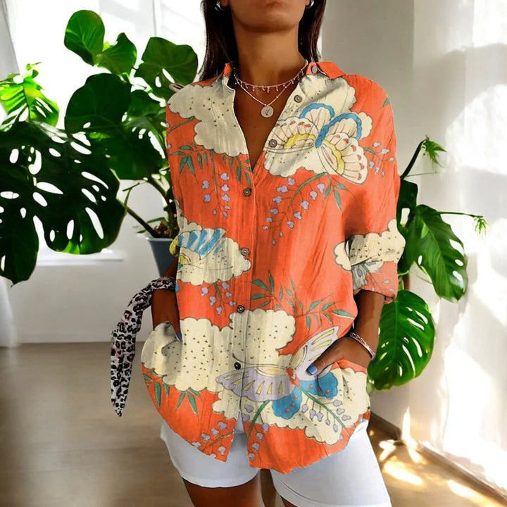 Women's floral print blouse styled with trousers showing relaxed silhouette and button closure