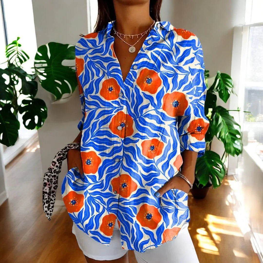 Detail of hibiscus floral print blouse featuring pink and green botanical pattern