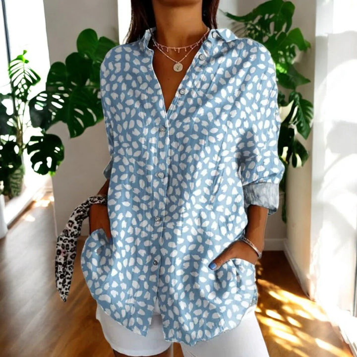 Back view of floral print blouse showing relaxed fit and oversized hibiscus pattern