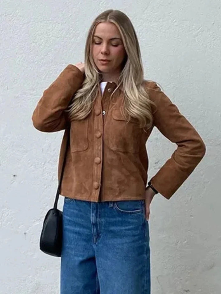Side view of cropped suede shirt jacket with structured fit and long sleeves