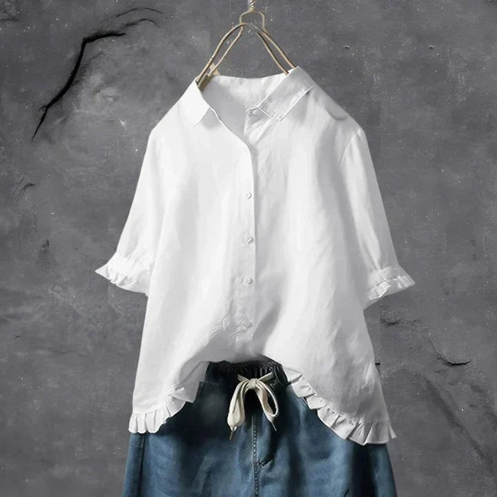 Women's ruffle trim linen shirt in white with relaxed fit and button-down collar displayed on hanger