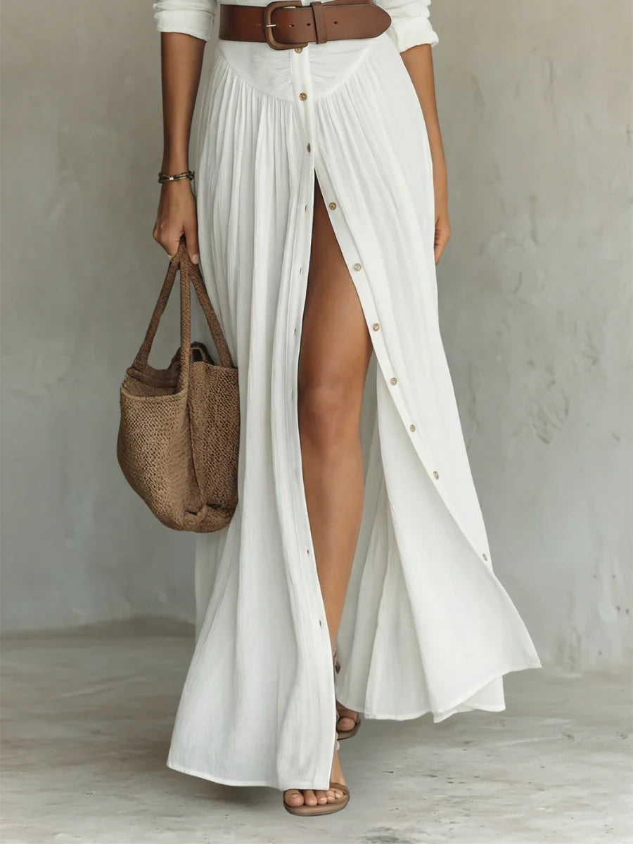 Front view of pleated maxi shirt dress showing gathered waist and flowing skirt with front slit