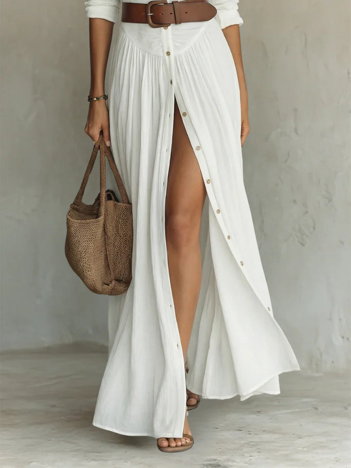 Front view of pleated maxi shirt dress showing gathered waist and flowing skirt with front slit