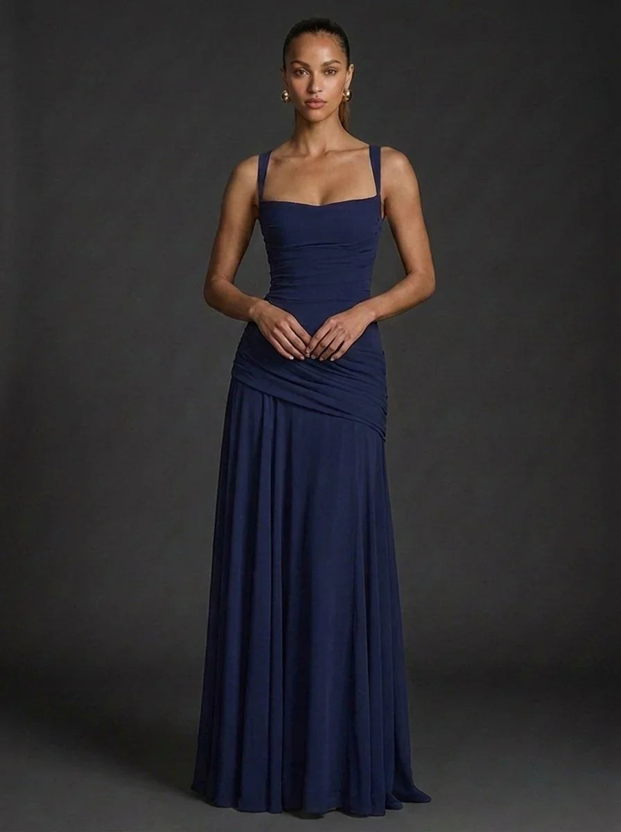 Side angle of fitted maxi dress with flared hem and smooth fabric drape