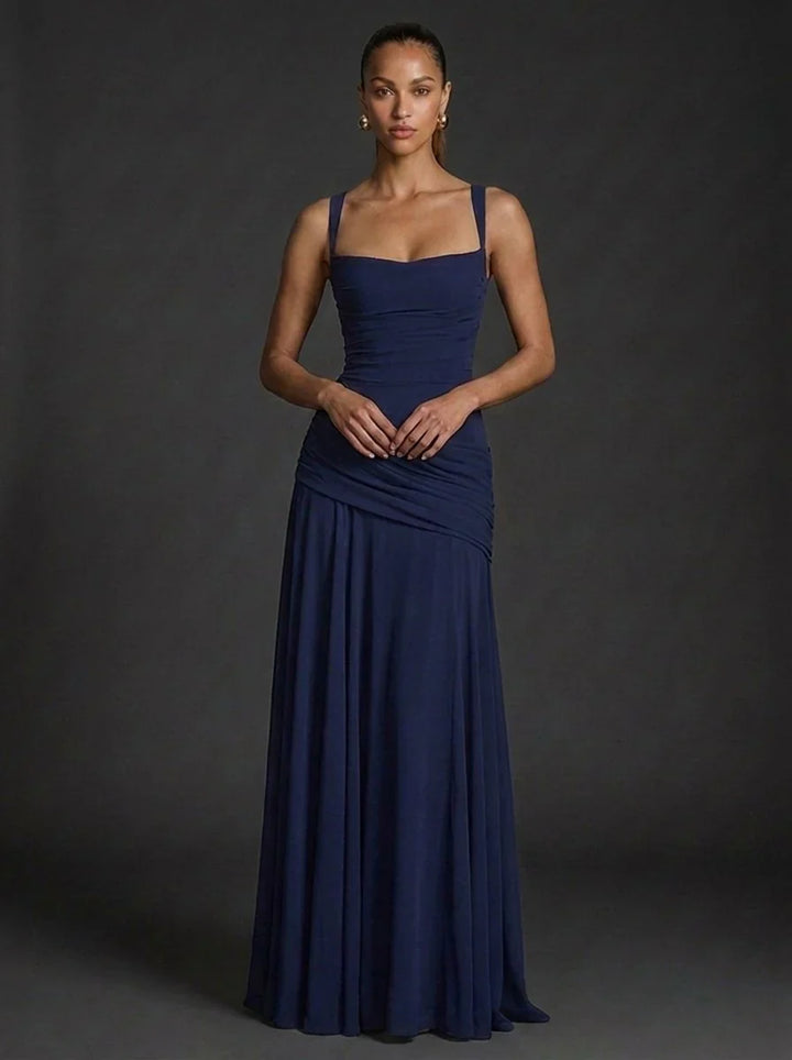 Side angle of fitted maxi dress with flared hem and smooth fabric drape