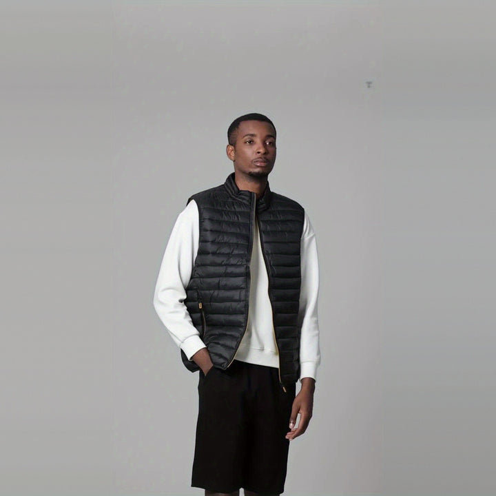 Men's lightweight quilted gilet in black, worn by a model