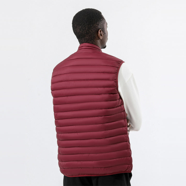 Men's lightweight quilted gilet in dark red, back view worn by a model