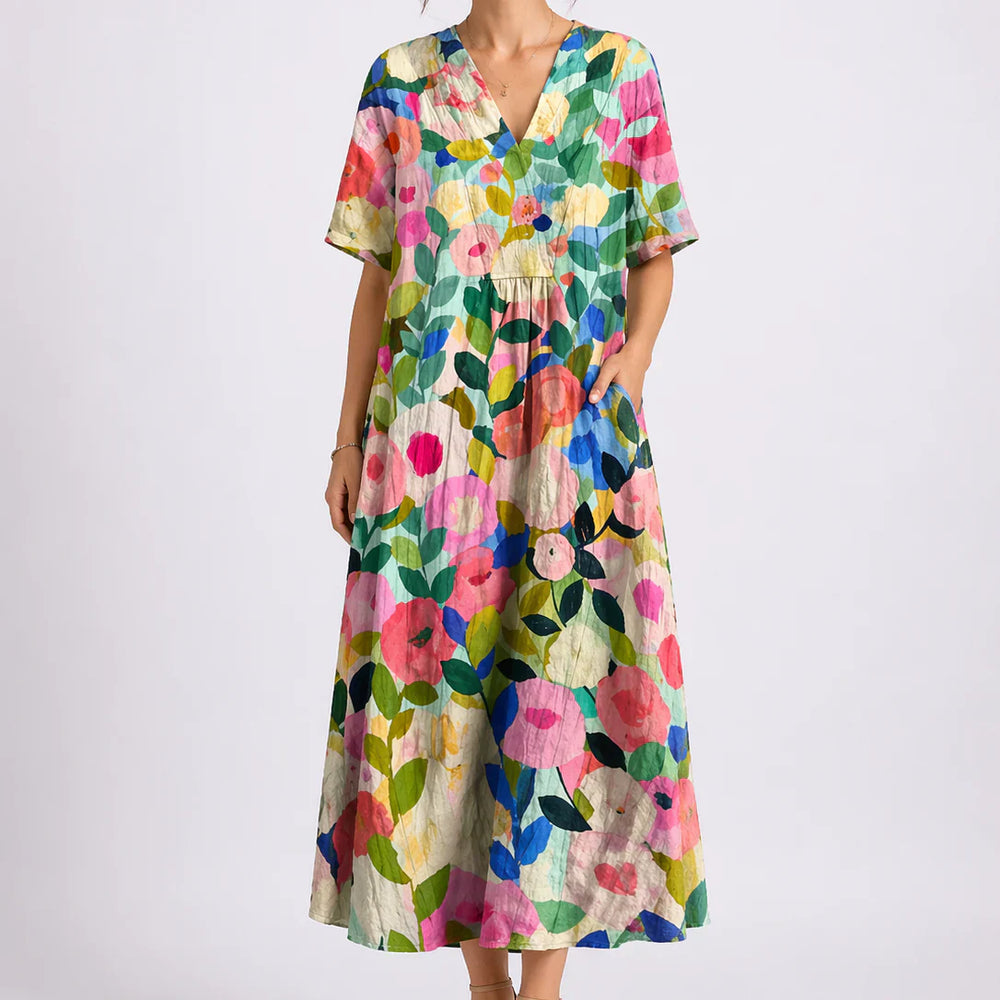Close-up of floral midi dress showing gathered waist and flowing skirt detail