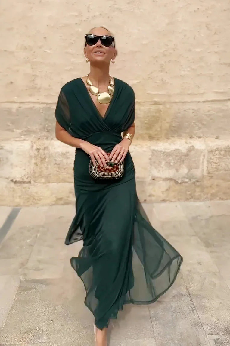 Close-up view of V-neck maxi dress bodice showing wrap-style construction and mesh sleeve detailing