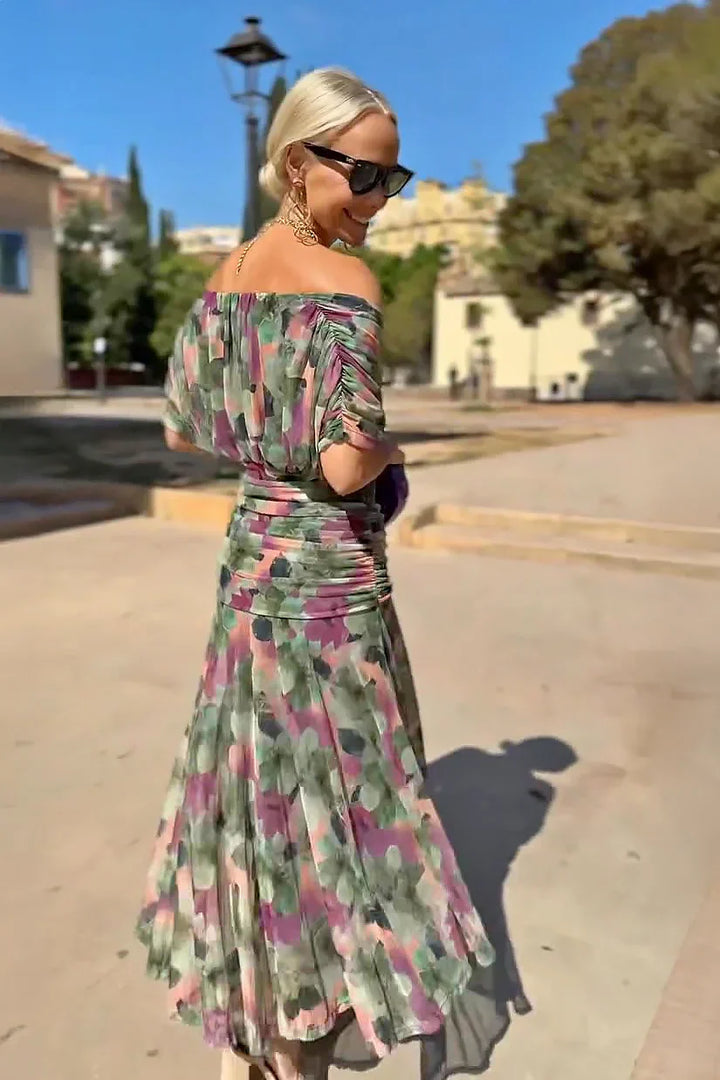 Woman styling emerald maxi dress with statement gold jewellery and strappy sandals