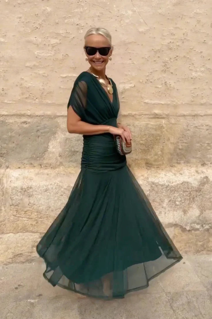 Movement shot showing layered skirt construction and flowing silhouette of maxi dress