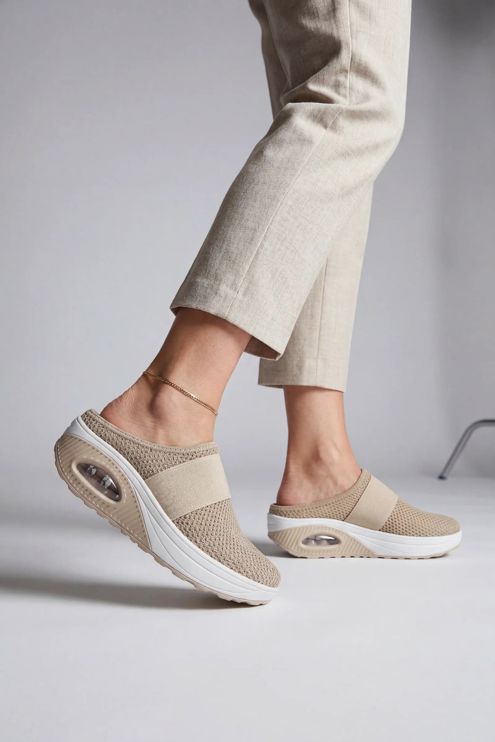 Side view of women's mules showing breathable mesh upper and air-cushion sole construction