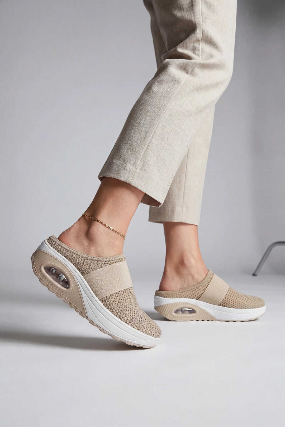 Side view of women's mules showing breathable mesh upper and air-cushion sole construction