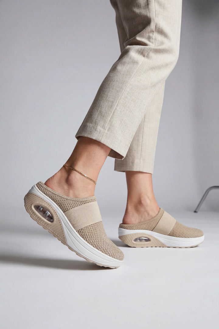 Side view of women's mules showing breathable mesh upper and air-cushion sole construction
