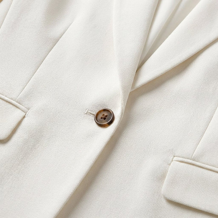 Side view of women's tailored blazer showing fitted silhouette and sleeve detail