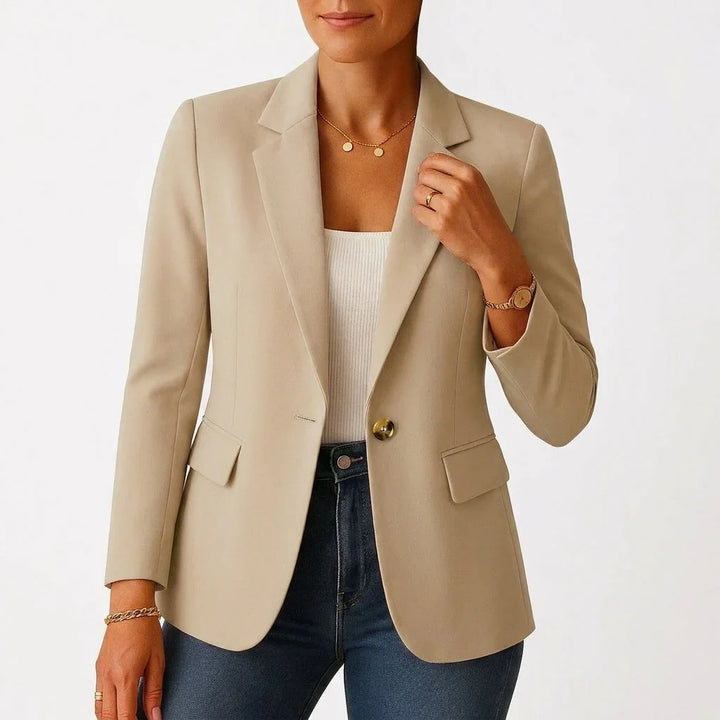 Close-up of single-button closure and notch lapel detail on white blazer