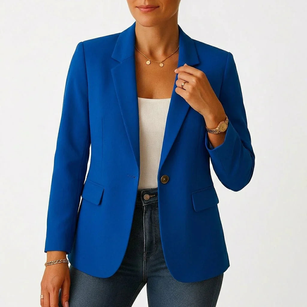 Detail of flap pocket and button closure on tailored blazer