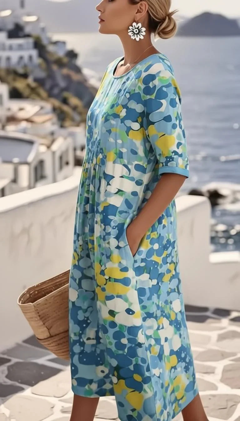 Close-up view of abstract floral print midi dress showing vibrant blue and yellow pattern details