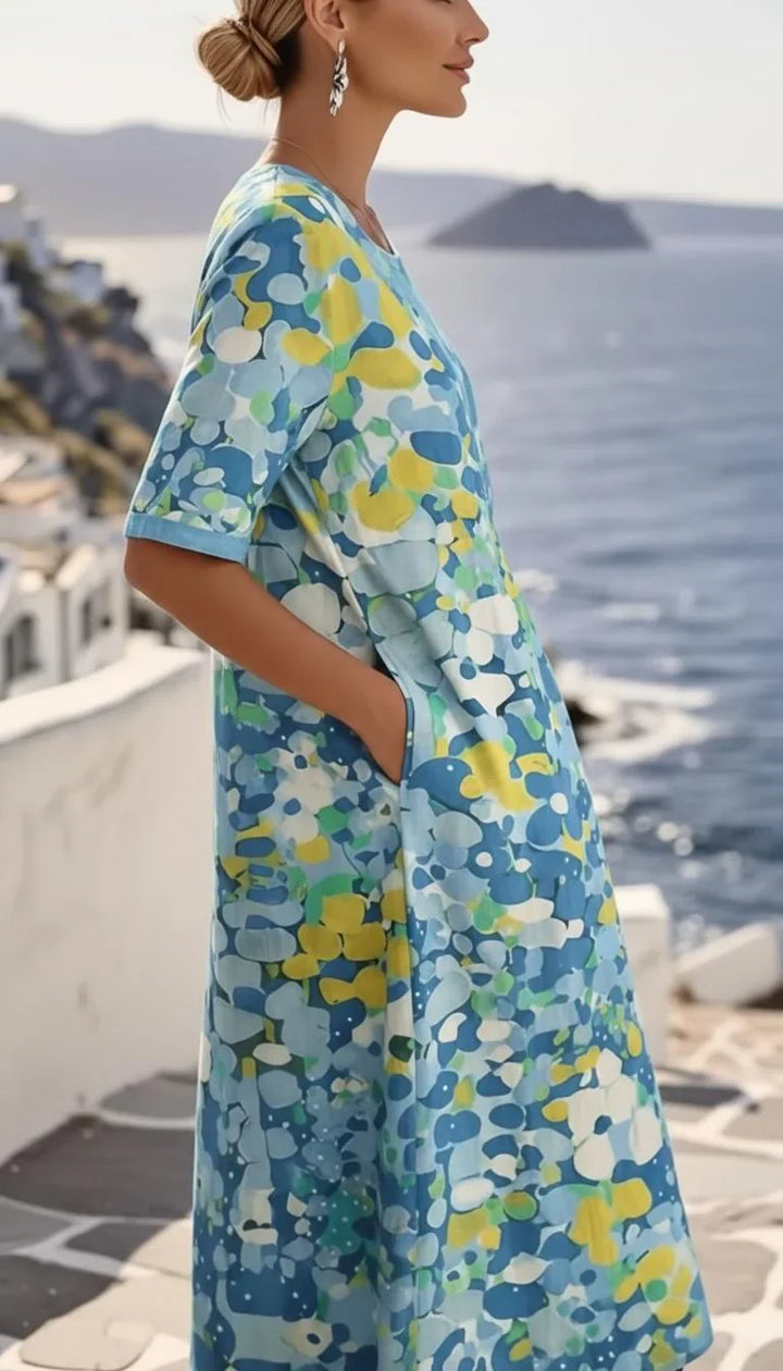 Side view of relaxed-fit midi dress with short sleeves and A-line silhouette in abstract print