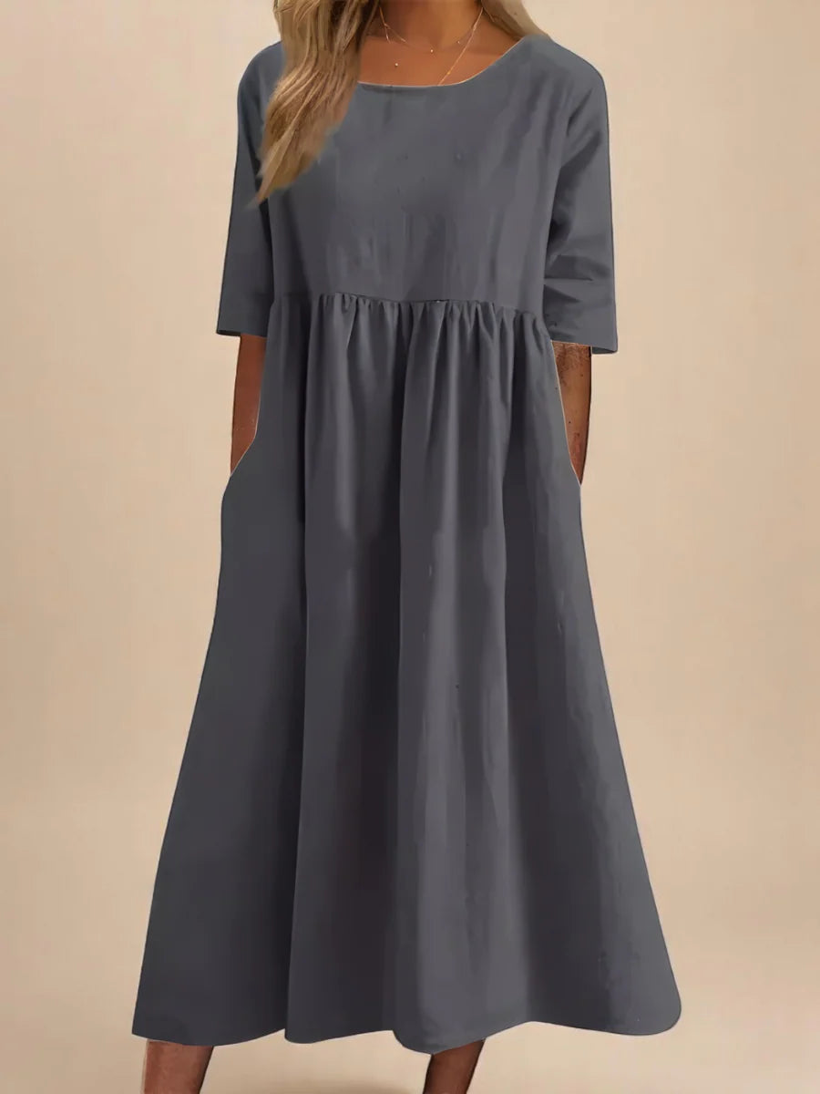Side view of relaxed midi dress showing gathered waist and flowing skirt silhouette