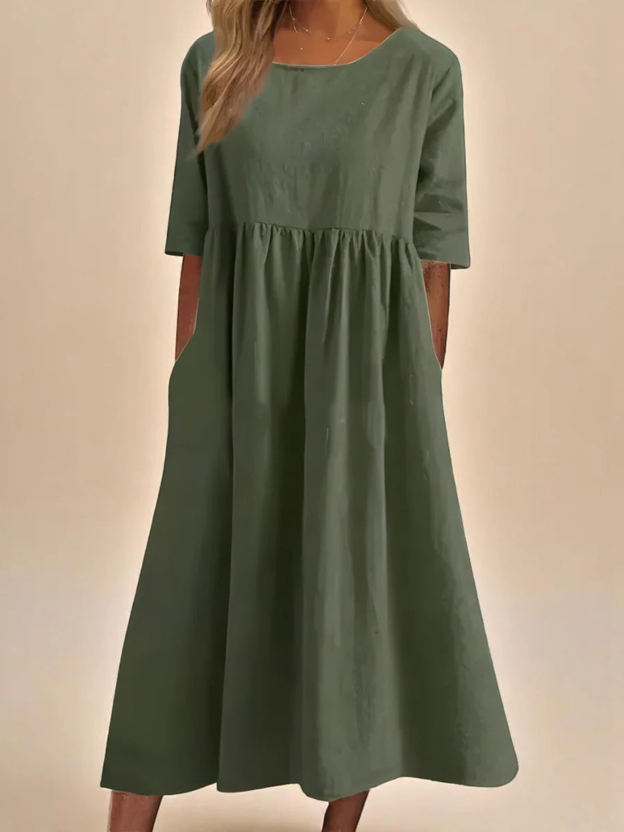 Close-up of round neckline and mid-length sleeves on relaxed midi dress