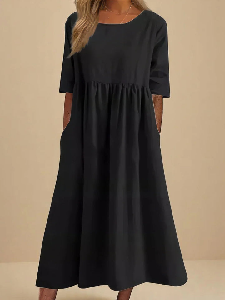 Full-length view of relaxed midi dress with practical side pockets and A-line cut