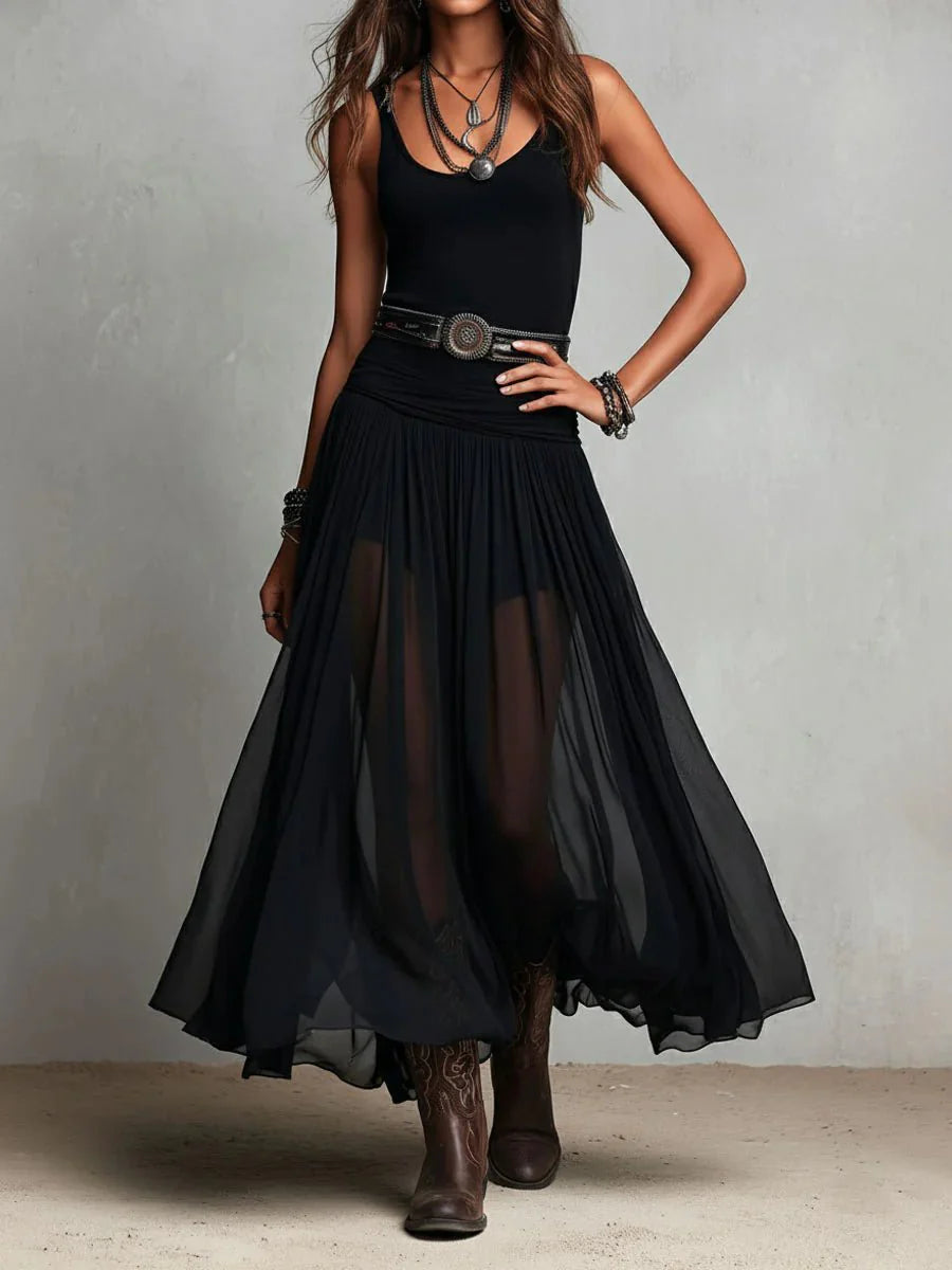 Close-up view of sleeveless maxi dress showing semi-sheer tulle skirt and ornate belt detail