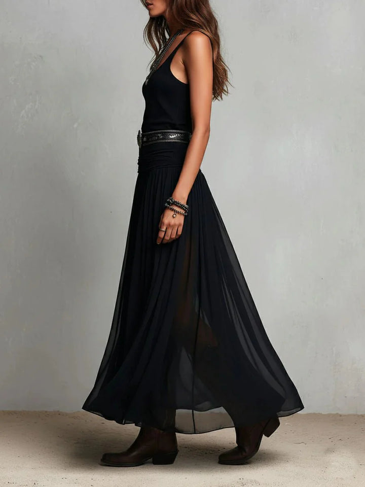 Back view of sleeveless maxi dress showing flowing semi-sheer skirt movement