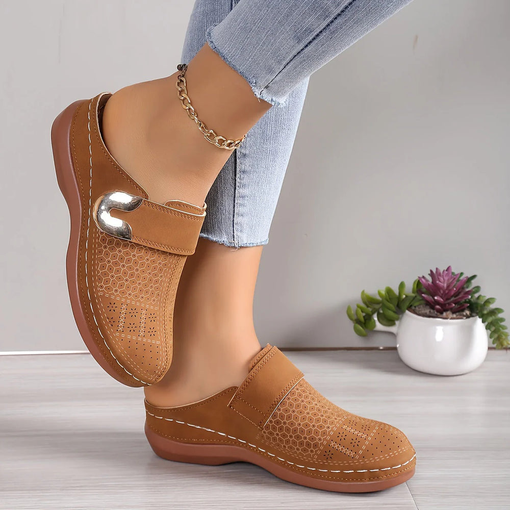 Close-up of women's slip-on mules showing cushioned footbed and non-slip sole construction